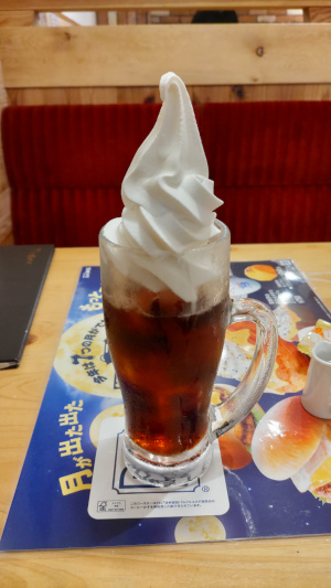 アイスコーヒーの上にソフトクリームが乗っているもの。コメダ珈琲のメニューです。テーブルの上に乗っているところを撮影